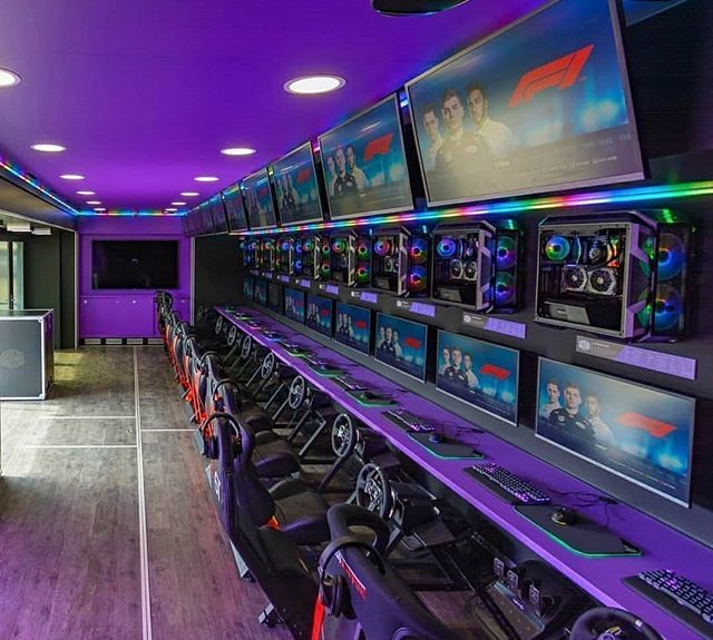 Modern High-Tech Gaming Room with Vibrant Lighting and Racing Simulation Setup