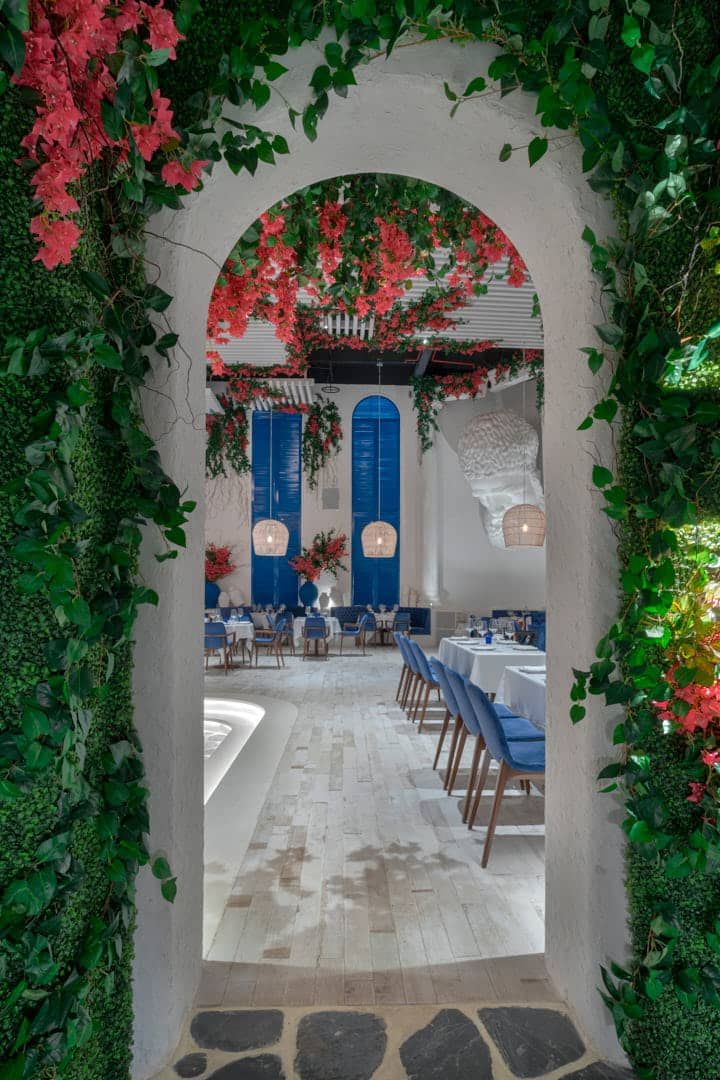 Welcoming Cafe Design Blending Lush Greenery and Elegant Decor for a Serene Dining Experience