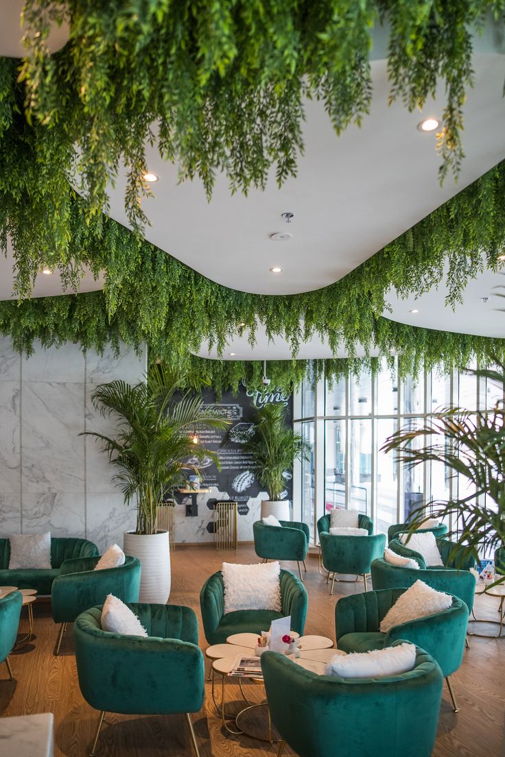 Contemporary Cafe Design: A Serene Oasis with Lush Greenery and Inviting Atmosphere