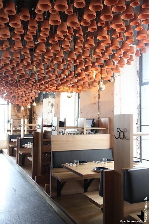 Striking Cafe Design Blends Terracotta Pots, Minimalist Furnishings, and Natural Light for a Cozy Atmosphere