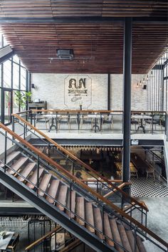 Inviting Cafe Design Blends Industrial and Modern Aesthetics with Abundant Natural Light and Greenery