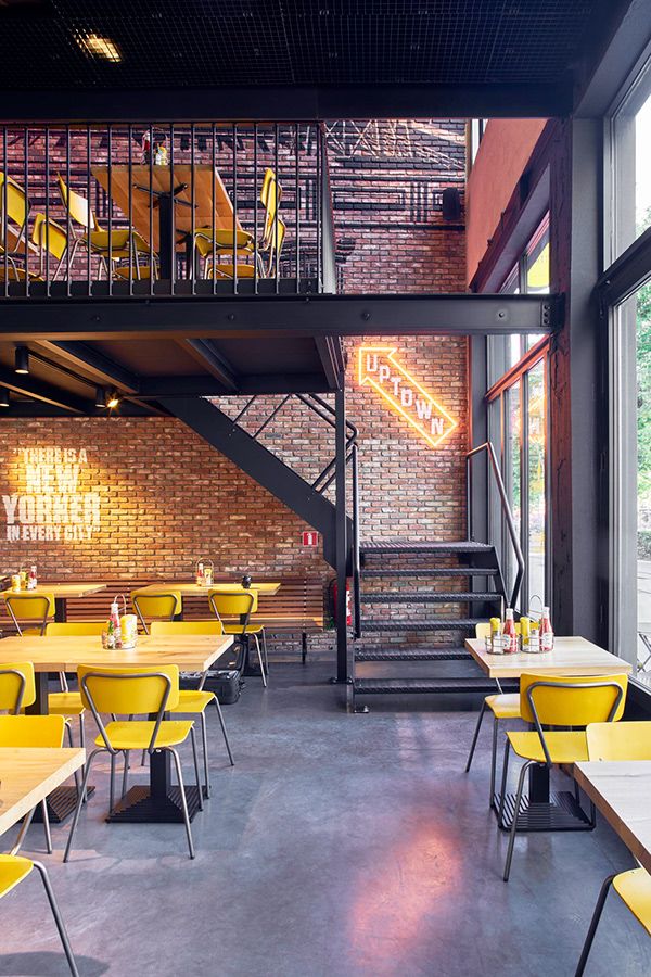 Modern Cafe Design Blends Industrial Elements with Cozy Ambiance and Vibrant Aesthetics