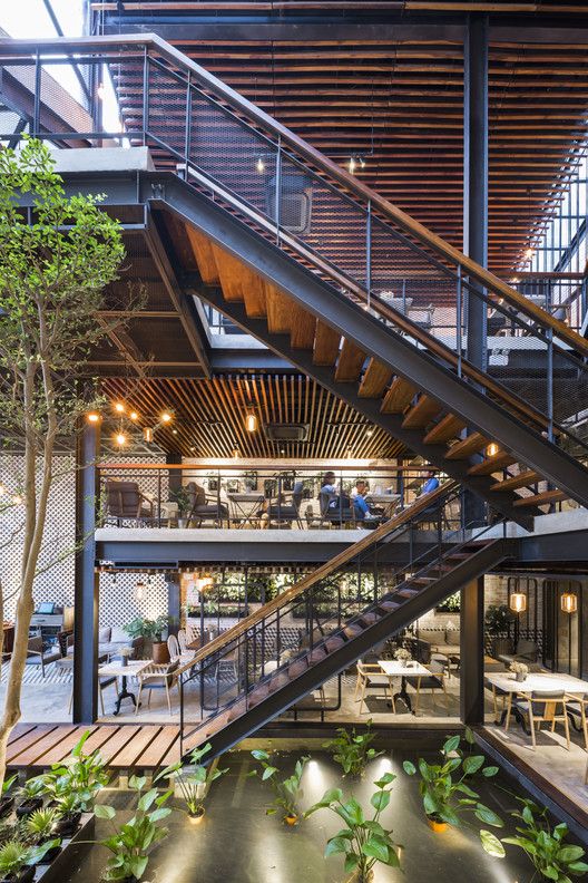 Chic Two-Level Cafe Design Blends Contemporary Comfort with Natural Elements