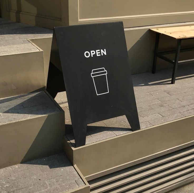 Minimalist Cafe Design with Modern Elements Creates Inviting Open-Air Atmosphere