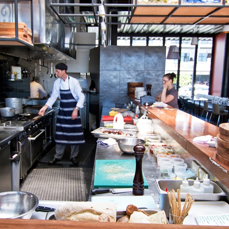 Engaging Cafe Design with Open Kitchen and Inviting Aesthetic