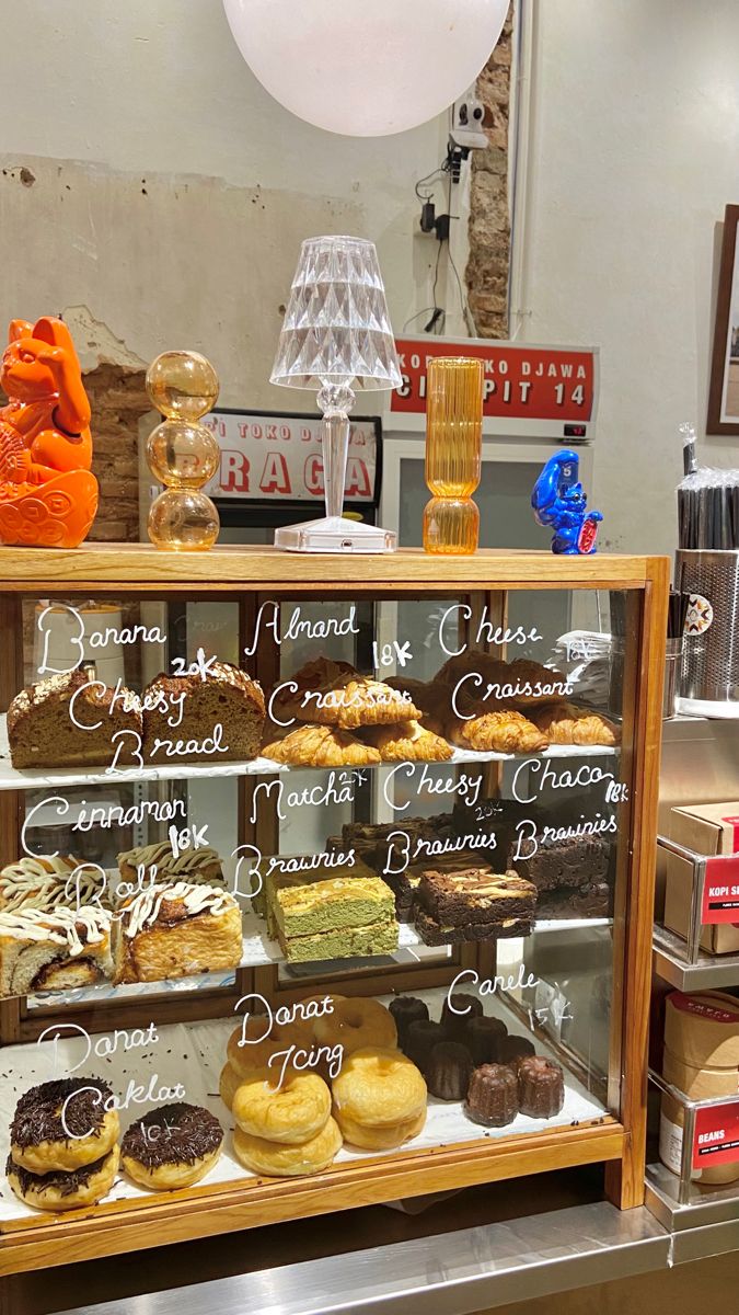 Warm and Inviting Cafe Design Showcases Baked Goods with Artistic Touches