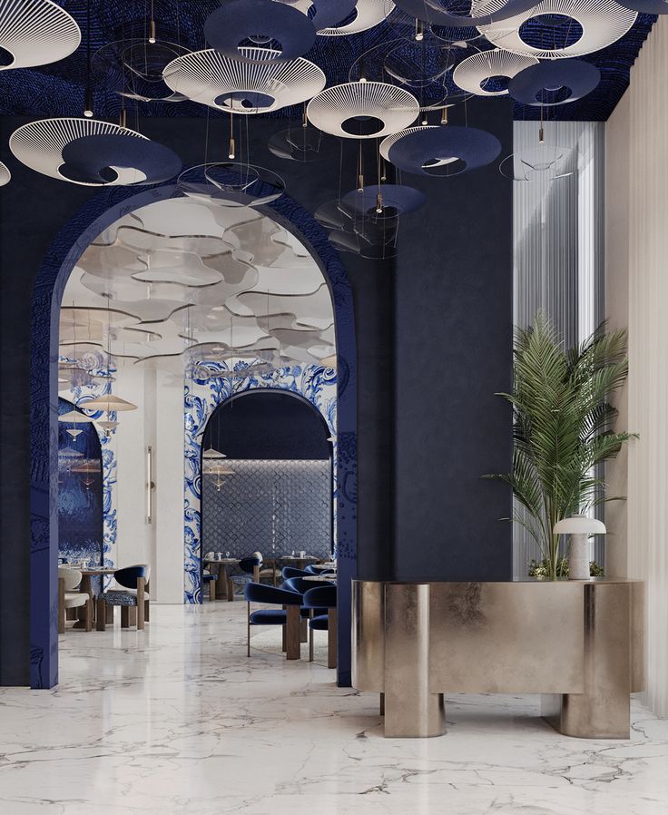 Elegant Cafe Design: Modern Aesthetic with Navy and White Elements, Artistic Lighting, Plush Seating, Marble Flooring, and Greenery