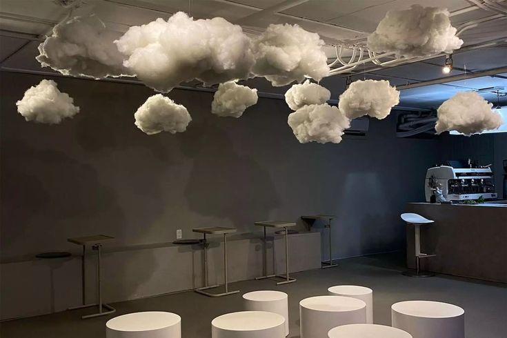 Whimsical Cafe Design with Cloud-Like Sculptures and Minimalist Aesthetic Promotes Relaxation and Creativity