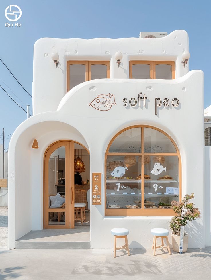 Charming Minimalist Cafe Design with Inviting Facade and Whimsical Accents