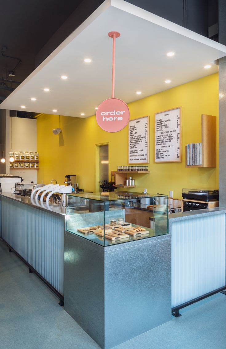 Modern Cafe Design: Cheerful Aesthetic with Sleek Displays and Inviting Ambiance