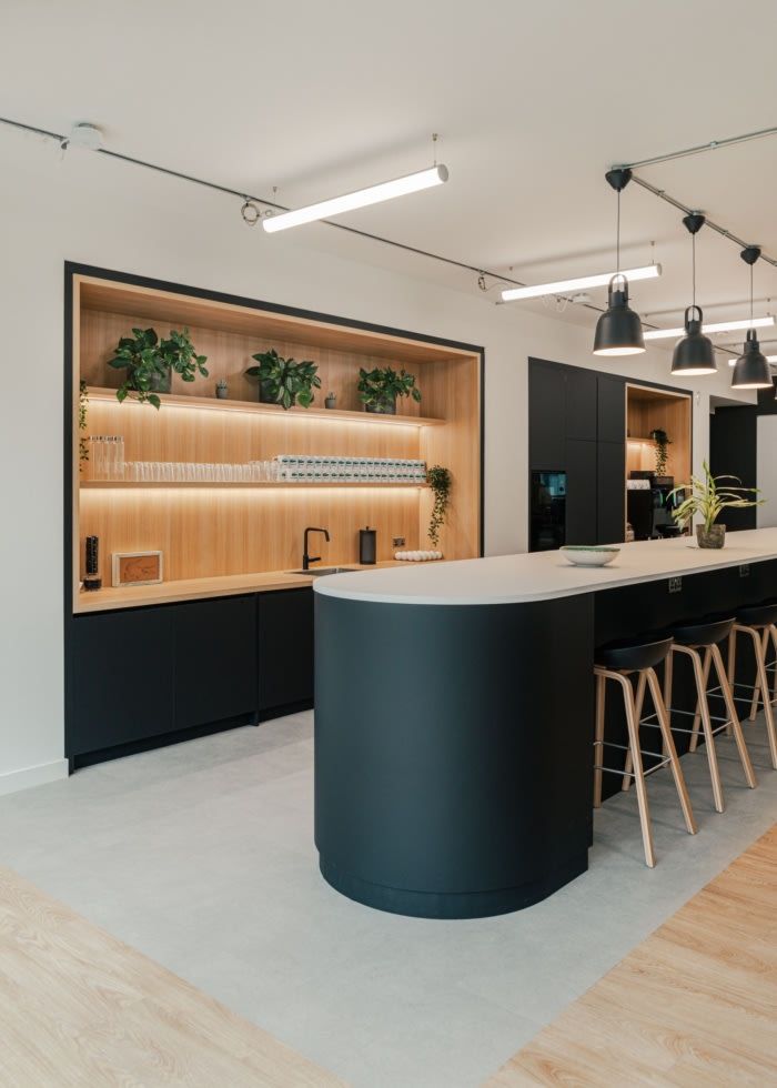 Sleek, Modern Cafe Design: Curved Island Bar and Inviting Atmosphere