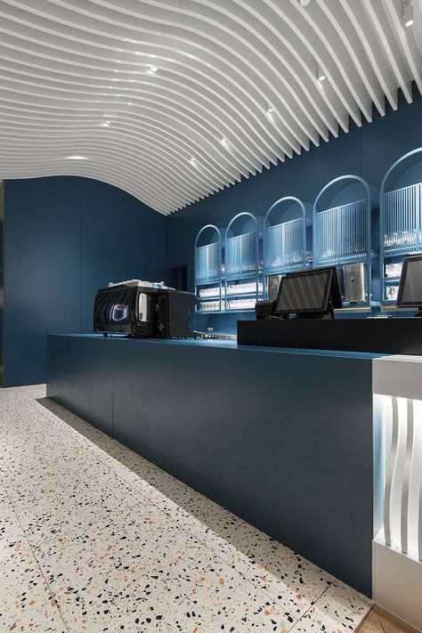 Modern Cafe Design: Striking Deep Blue Walls and Textured Ceilings Create Inviting Atmosphere