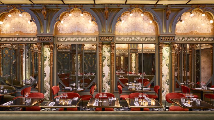 Luxurious Cafe Design Featuring Opulent Arches, Rich Upholstery, and Elegant Lighting