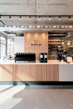 Sleek Modern Cafe Design with Polished Wood, Airy Palette, and Inviting Natural Light