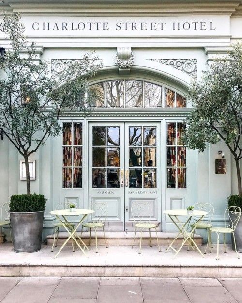 Charming Cafe Design: Inviting Pastel Facade with Elegant Outdoor Seating and Cozy Atmosphere