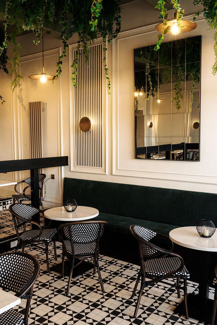 Chic Cafe Design: Monochromatic Elegance with Greenery and Cozy Accents