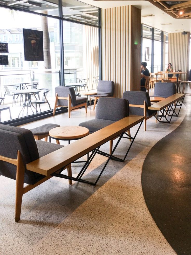 Modern Cafe Design: Open Layout with Inviting Minimalist Seating and Natural Light