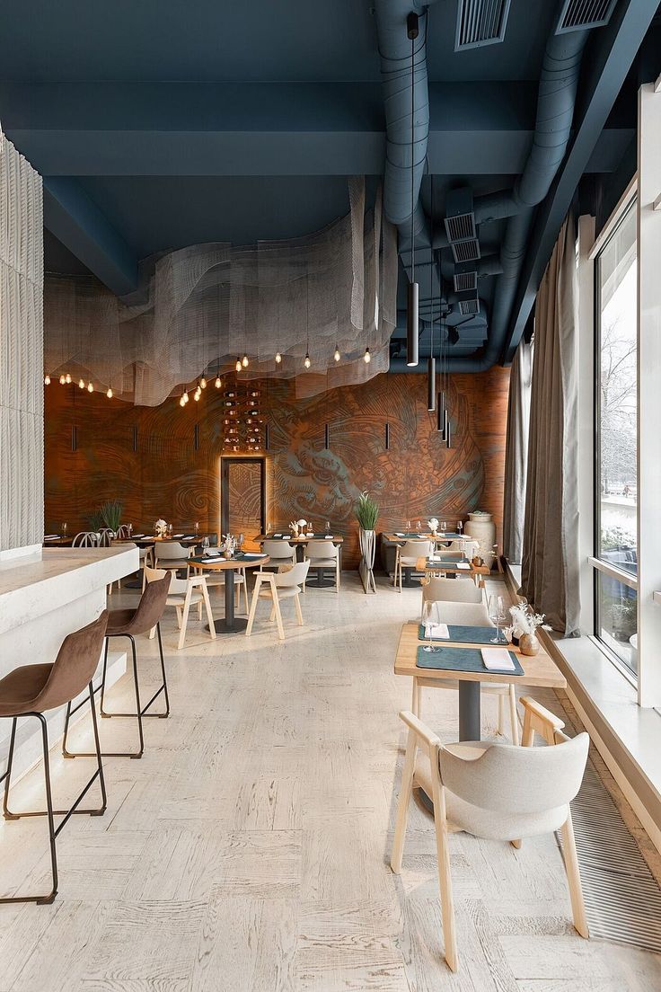 Modern Cafe Design: Vibrant Mural and Airy Ambiance with Inviting Lighting