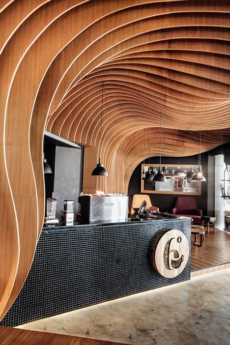 Modern Cafe Design: A Harmonious Blend of Wave-Like Wood, Light Play, and Urban Sophistication