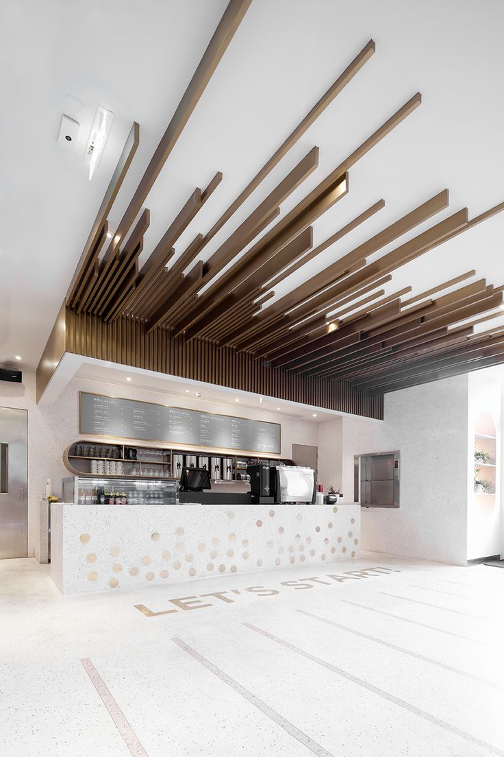 Modern Cafe Design with Striking Layered Wooden Ceiling and Stylish Terrazzo Counter