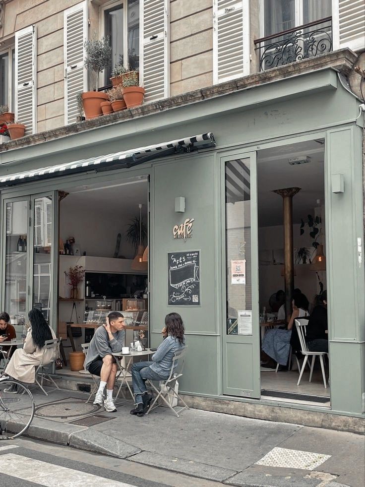 Charming Cafe with Airy Pastel Green Facade and Inviting Atmosphere