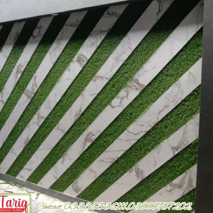 Dynamic Cafe Wall Design: Combining Angular Artificial Grass with Marbled Panels for a Modern Aesthetic