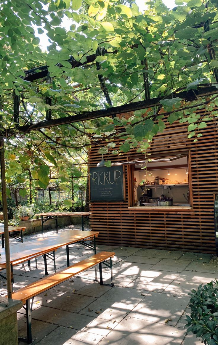 Charming Cafe Design Blends Wooden Facade with Nature for a Cozy, Inviting Atmosphere