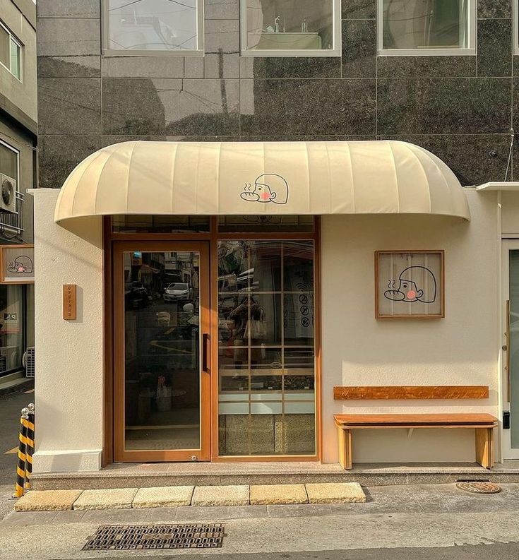 Charming Cafe Design: Welcoming Facade with Curved Awning and Cozy Atmosphere