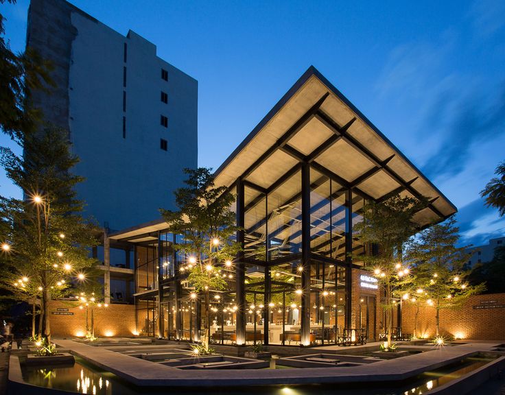 Modern Cafe Design with Geometric Roof, Glass Walls, and Integrated Greenery