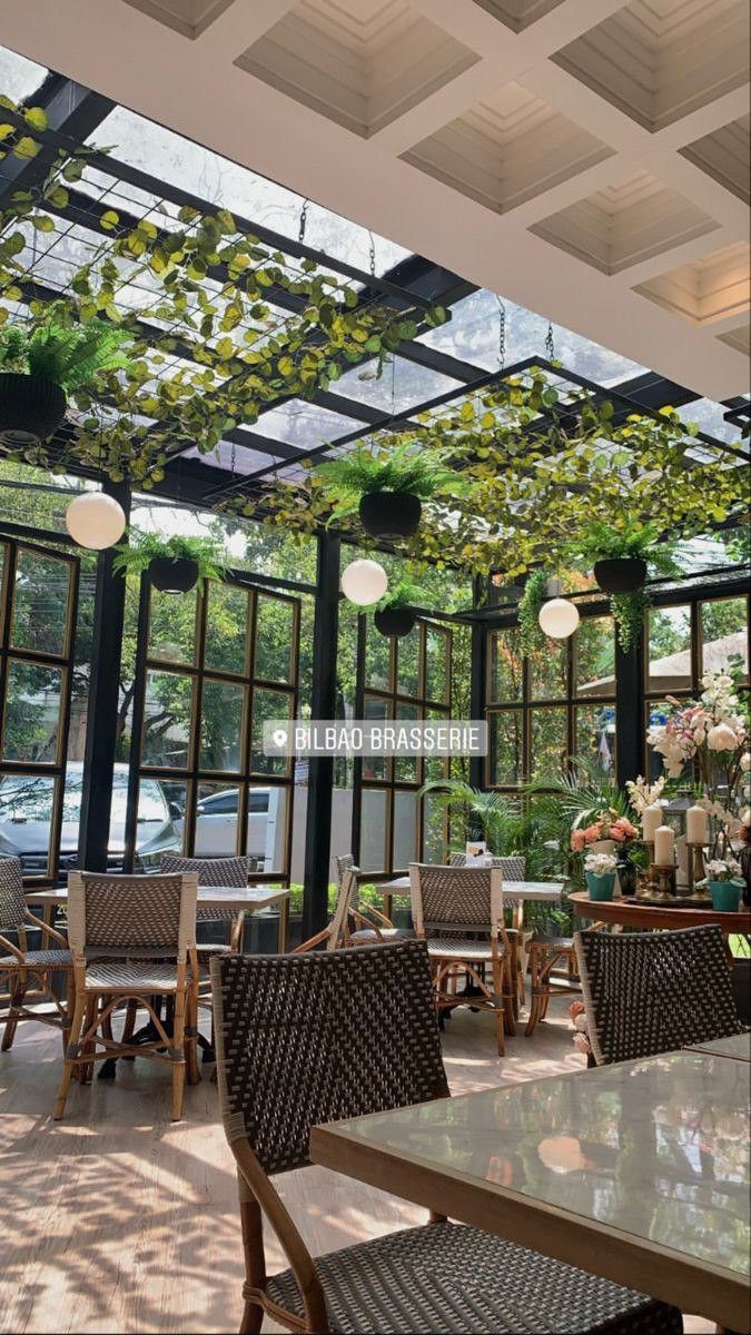 Charming Cafe with Bright Design, Lush Greenery, and Cozy Ambiance