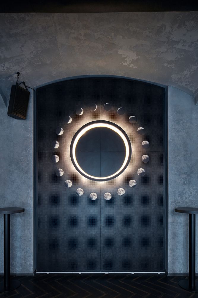 Cafe Design: A Cosmic-Inspired Circular Light Installation Enhancing Modern Elegance