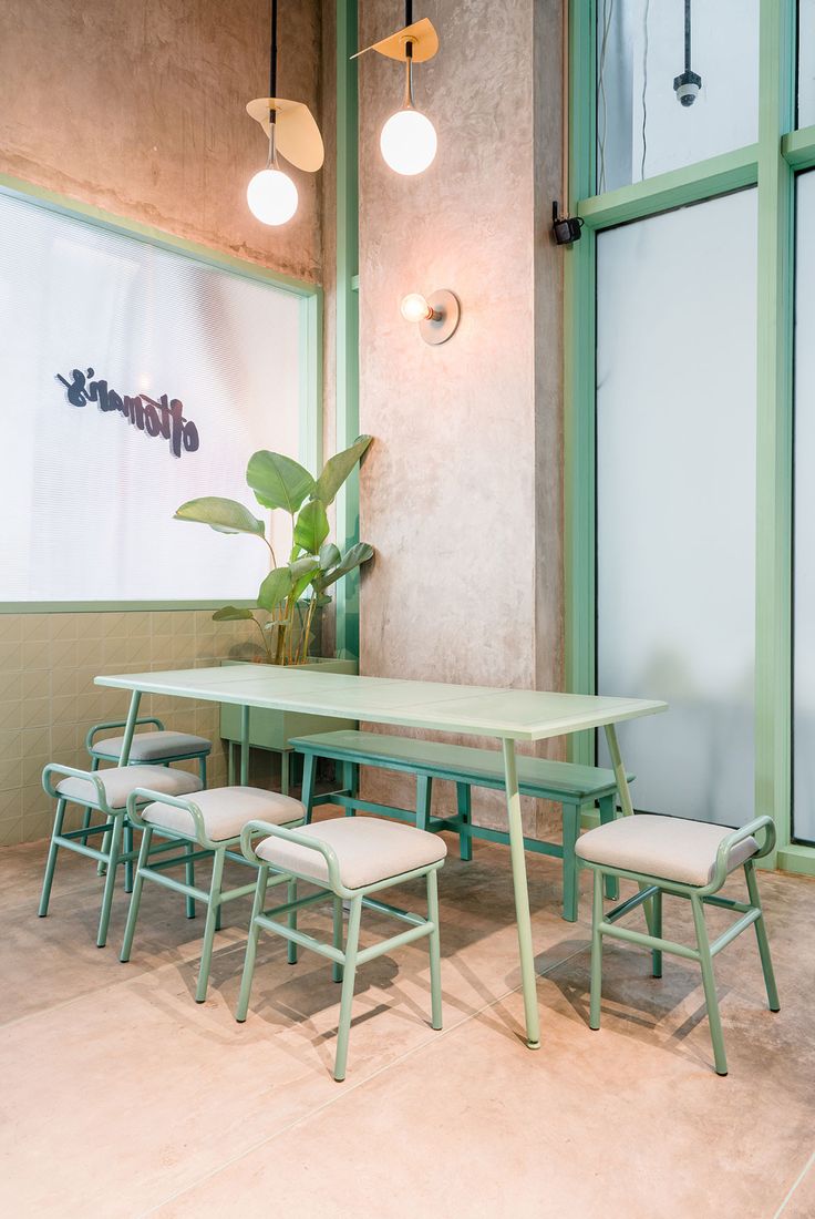 Harmonious Minimalist Cafe Design with Soft Green Palette and Inviting Atmosphere