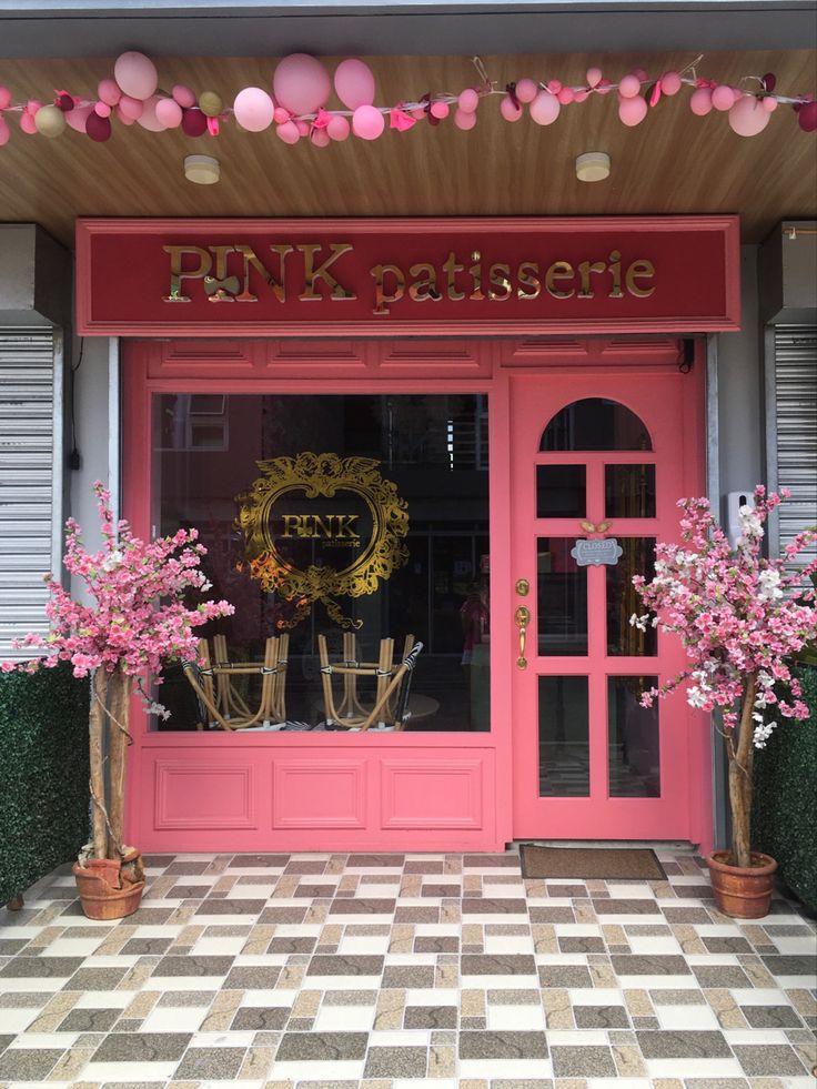 Charming Cafe Design: Vibrant Pink Facade with Whimsical Elements for an Inviting Atmosphere