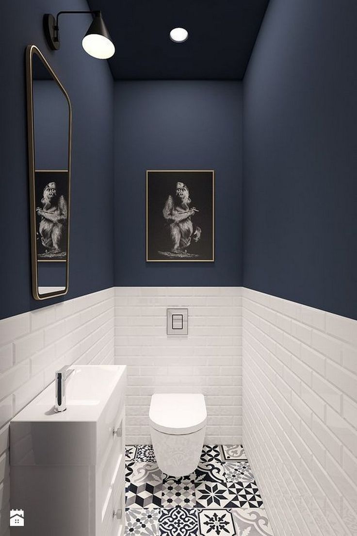 Chic Cafe Bathroom Design: A Cozy Fusion of Deep Blue and White with Artistic Accents