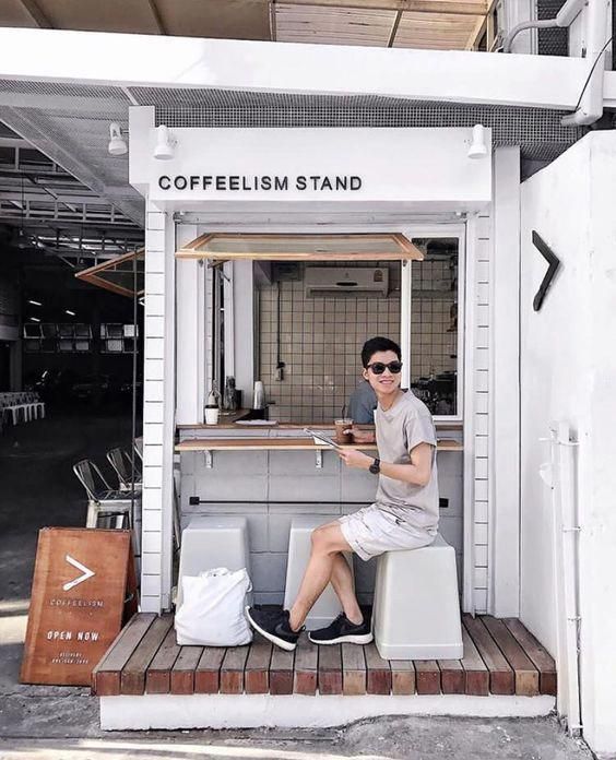 Modern Minimalist Cafe Design: Inviting Coffee Stand with Natural Elements and Urban Chic Appeal