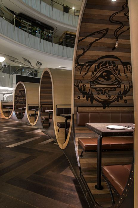 Contemporary Cafe Design: Cozy Circular Booths and Inviting Atmosphere with Artistic Touches