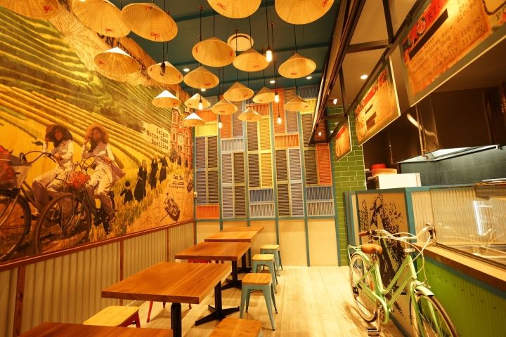 Eclectic Cafe Design Combines Bold Murals, Warm Lighting, and Rustic Charm for a Cozy Atmosphere