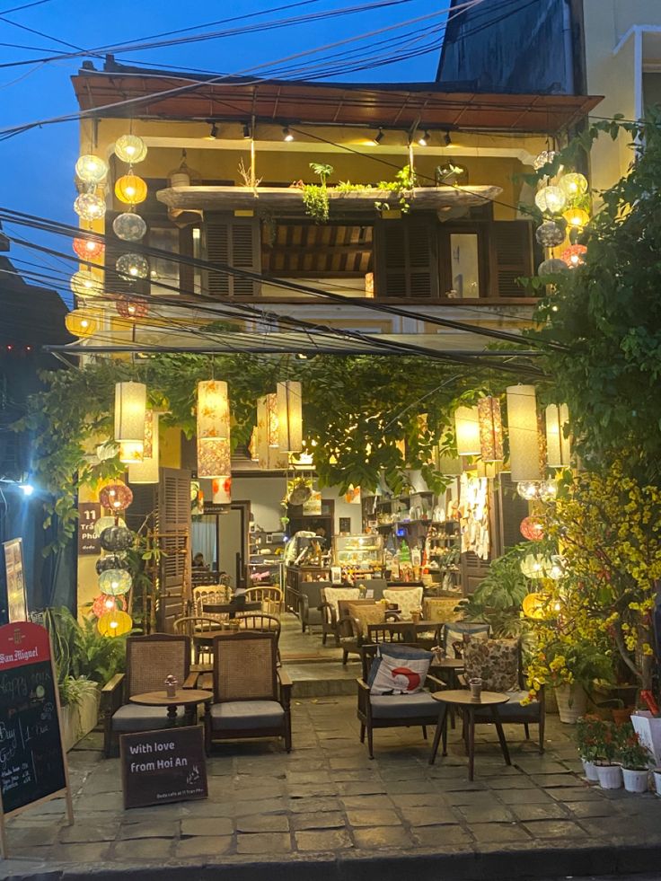 Charming Two-Story Cafe with Colorful Lanterns and Cozy Outdoor Atmosphere