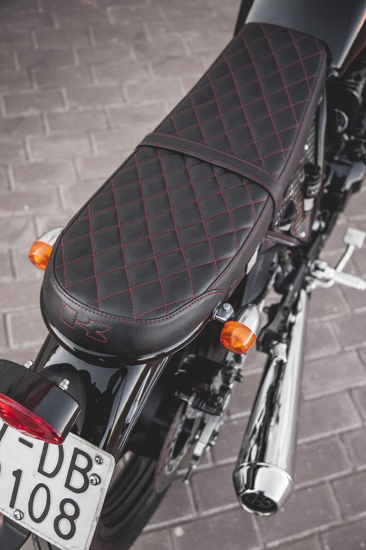 Sleek, Modern Motorcycle Seat with Diamond Quilted Black Leather and Red Stitching