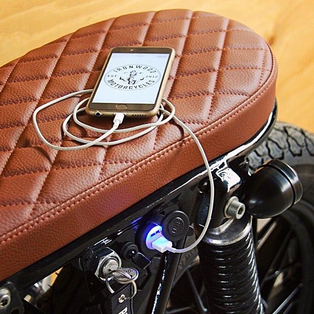 Vintage Motorcycle Seat Merges Retro Elegance with Modern Functionality in Hip Cafe Setting