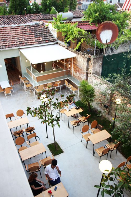 Modern Cafe Design Combines Spacious Outdoor Area with Inviting Aesthetic