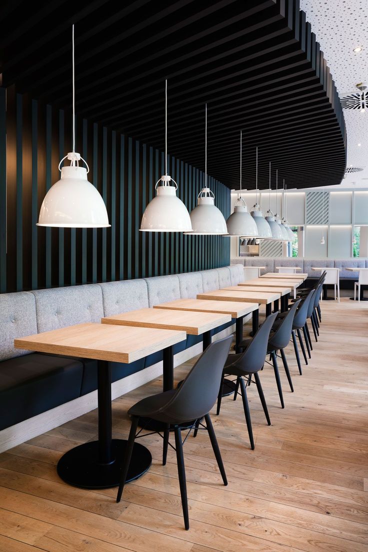 Modern Cafe Design: Sleek Contrast of Dark Wood and Light Furnishings in an Inviting Atmosphere