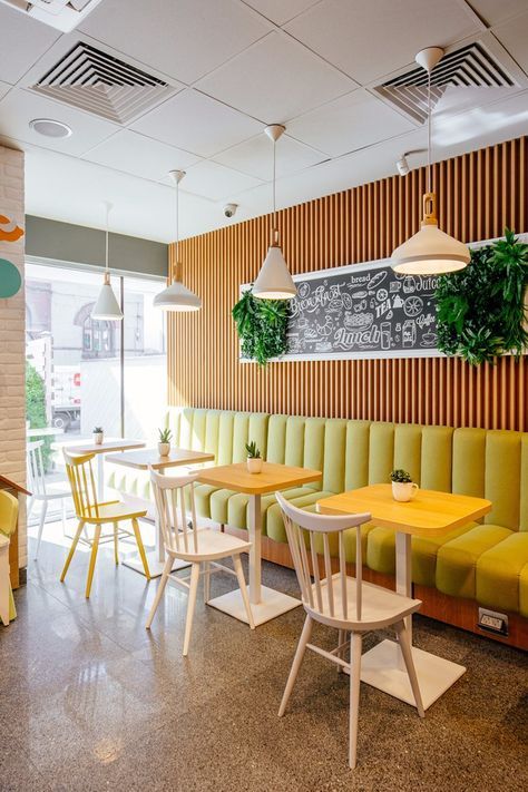 Modern Cafe Design: Inviting Interiors with Cozy Yellow Seating and Natural Accents