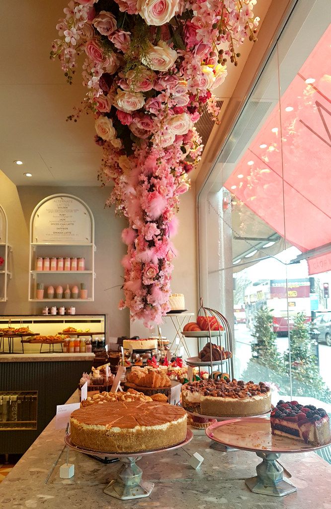 Charming Cafe Design Showcases Stunning Floral Installations and Elegant Dessert Displays