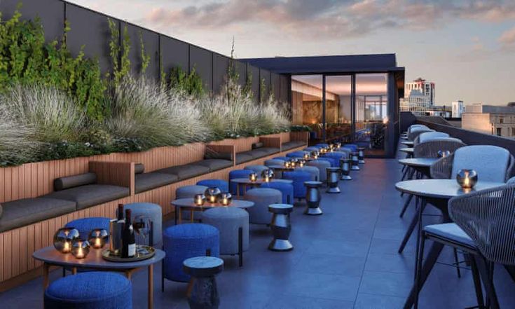 Chic Rooftop Terrace Cafe: A Modern, Inviting Space with Lush Greenery and Intimate Dining