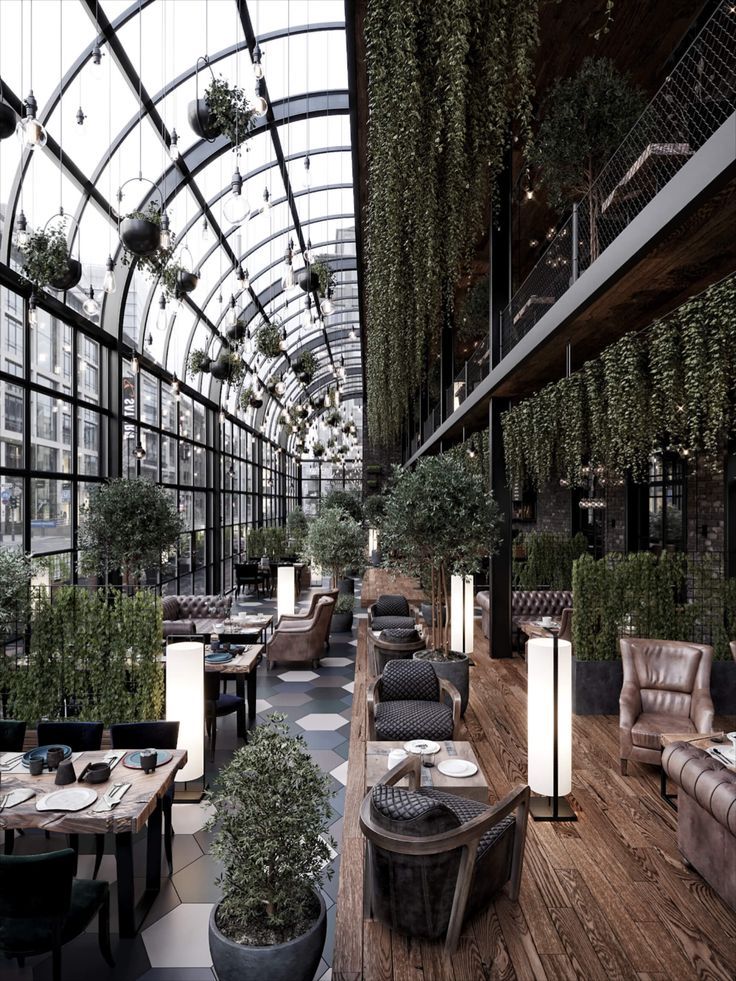 Modern Cafe Design: Spacious, Inviting Atmosphere with Glass Roof and Lush Greenery