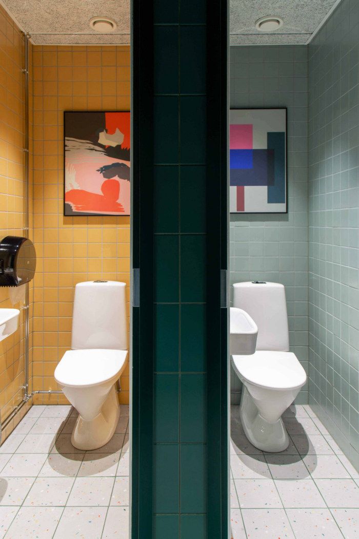 Vibrant Contemporary Restroom Design Enhances Cafe Ambiance with Bold Colors and Minimalist Aesthetics