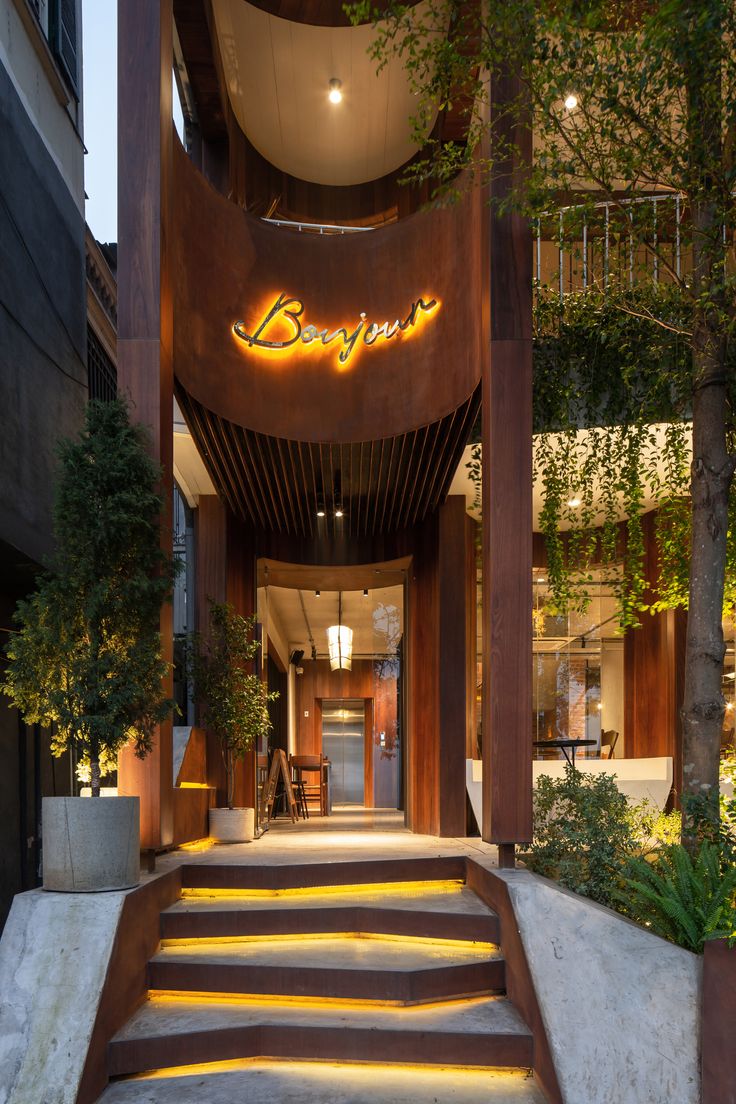 Inviting Cafe Entrance Blends Modern Design with Natural Elements for a Cozy Atmosphere