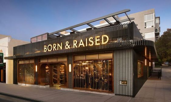 Modern Cafe Design Blends Sleek Facade with Warm Accents and Inviting Outdoor Seating