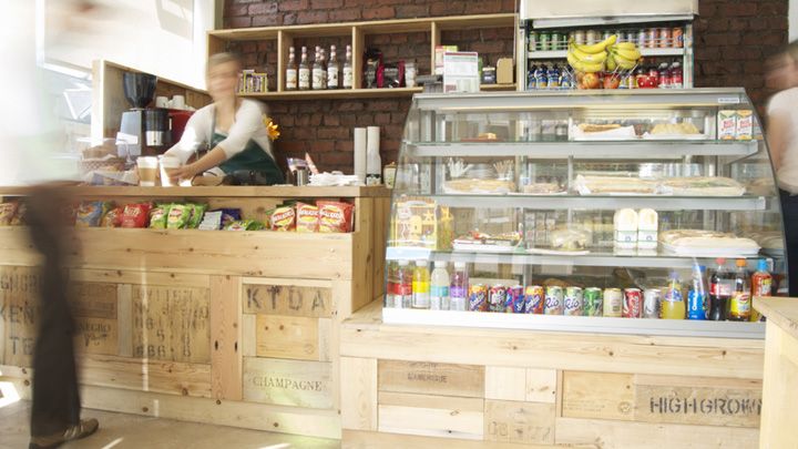 Rustic Cafe Design Creates a Cozy and Inviting Atmosphere with Wooden Crates and Brick Wall Features